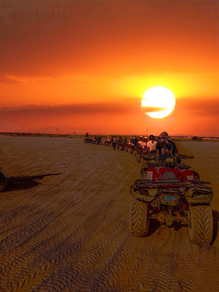 Quad bikers racing through the desert dunes
